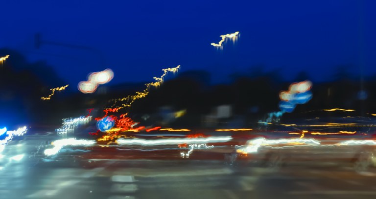 A blurry night scene of streaking traffic lights