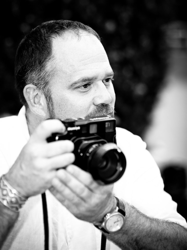 Photographer Jeremiah Armstrong holding a rangefinder camera