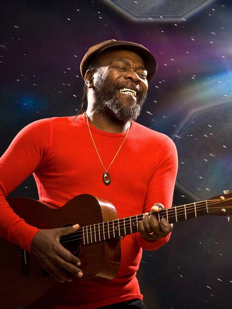 Reggae musician Clinton Fearon photographed in studio with a guitar
