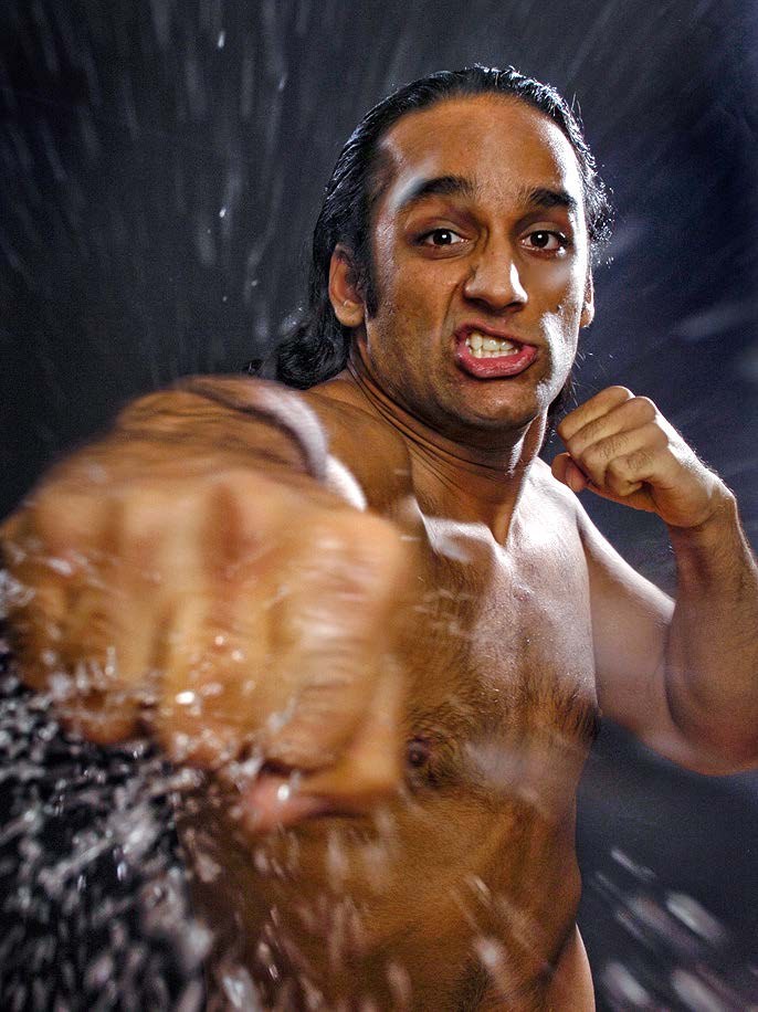 A water-drenched action portrait of a surfer