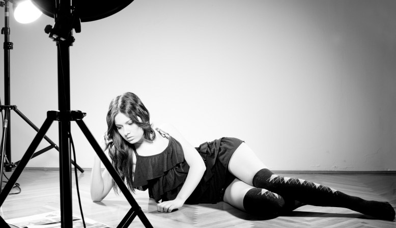 A black and white studio portrait lit with a single strobe