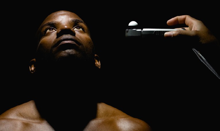 An incident light meter being held to measure the light falling on a model's face