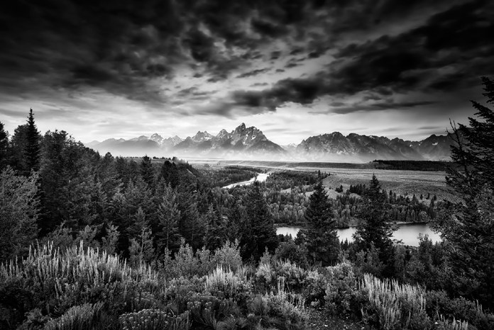 A dramatic black and white mountain landscape in the style of Ansel Adams
